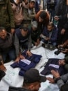 Palestinci, uglavnom novinari, okupljeni oko tijela pet palestinskih novinara ubijenih u izraelskom vazdušnom udaru u Gazi, 26. decembra 2024. (Foto: AP/Abdel Kareem Hana)