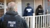 FILE - In this Feb. 9, 2017, photo provided U.S. Immigration and Customs Enforcement (ICE), ICE agents are seen at a home in Atlanta, Georgia, during a targeted enforcement operation aimed at immigration fugitives, re-entrants and at-large criminal aliens. 