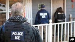 FILE - U.S. Immigration and Customs Enforcement, ICE agents at a home in Atlanta, Georgia.