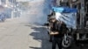 Rebaz Majeed takes photos on a street in Sulaymaniyah while covering anti-government protests on Dec. 3, 2020. (Courtesy, Hama Sur)
