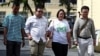 Panupong "Mike Rayong" Jadnok, Parit "Penguin" Chiwarak, Panusaya "Rung" Sithijirawattanakul and Arnon Nampa, a rights lawyer and protest leader arrive to report themselves to police summons at a police station in Bangkok, Thailand, Nov. 30, 2020. 