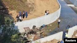 Ahli forensik bersama polisi Turki memeriksa sisa-sisa truk yang membawa migran setelah kecelakaan Izmir, Turki, 14 Oktober 2018.