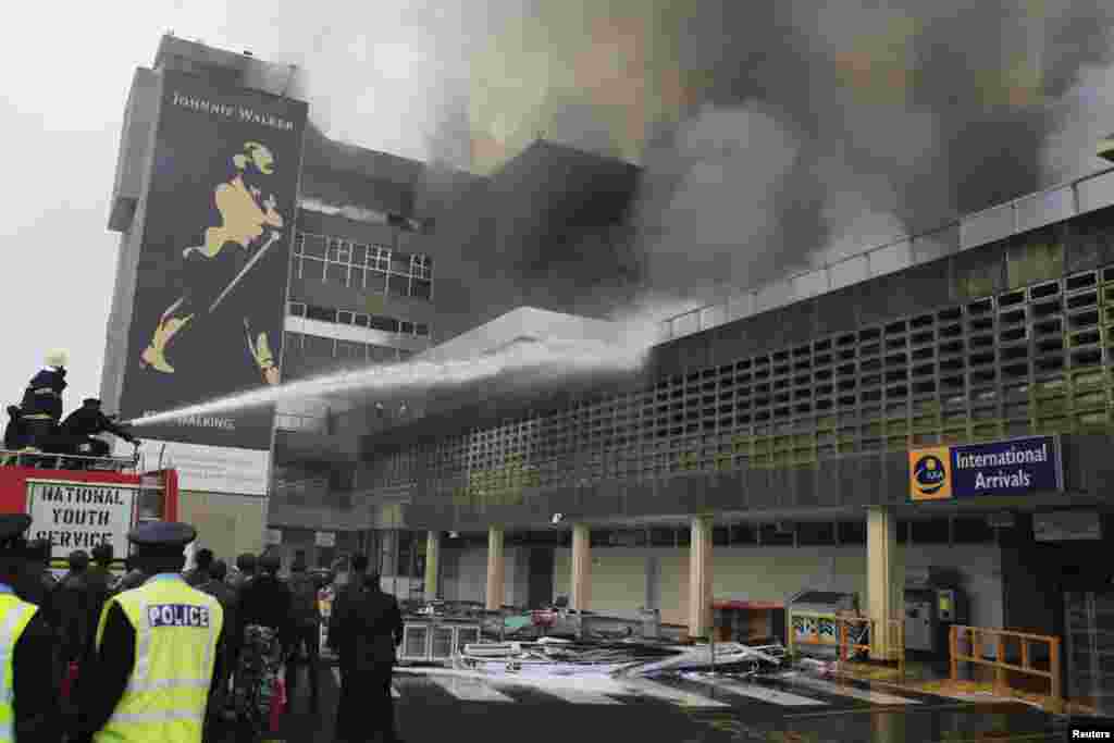 Firefighters struggle to put out a fire at the Jomo Kenyatta International Airport in Kenya's capital Nairobi, August 7, 2013.