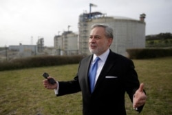 FILE - U.S. Secretary of Energy Dan Brouillette gestures during an interview after visiting the deepwater port in Sines, southern Portugal, Feb. 12, 2020.