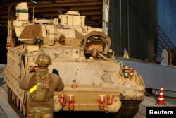 FILE - U.S. Army Bradley Fighting Vehicle leaves ship during operation Atlantic Resolve rotation in Riga port, Latvia Oct. 16, 2019.