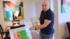 In his acrylic-filled home in Houston, artist Ammar Alobaidi flashes a May 2017 copy of Houstonia magazine, which features his work and life story.