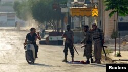 Rebel fighters from the hardline jihadist Jund al-Aqsa man a checkpoint in the Syrian town on Taybat al Imam town on August 31, 2016. 