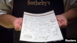 A Sotheby's employee shows the handwritten lyrics for Bob Dylan's 'Like a Rolling Stone' song that is part part of a collection from; 'A Rock and Roll History: Presley to Punk' at Sotheby's auction house in New York, June 20, 2014.