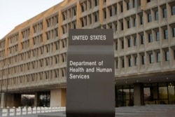 FILE - The Department of Health and Human Services building is seen in the evening in Washington.
