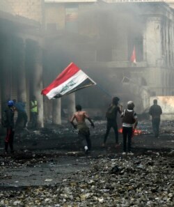 Anti-government protesters gather on Rasheed Street during clashes with security forces in Baghdad, Nov. 29, 2019.