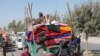 Afghan families leave their houses after fighting between the Afghan military and Taliban insurgents in Helmand province, southern of Afghanistan, Oct. 13, 2020. 