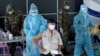 A man receives a dose of the Sinovac vaccine from China against the Covid-19 coronavirus at the Australian Centre for Education in Phnom Penh on May 1, 2021, as part of the government's campaign to halt the rising number of cases of the virus. (Photo by TANG CHHIN Sothy / AFP) 