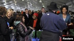 First Lady Michelle Obama (R) and Jill Biden (L), wife of Vice President Joe Biden, are seen participating in volunteer activities on a previous National Day of Service (file photo).