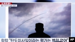 People watch a TV showing an image of North Korea's rocket launch during a news program at the Seoul Railway Station in Seoul, South Korea, Aug. 1, 2019.