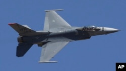 FILE - In this Feb. 24, 2019, file photo, U.S. fighter aircraft F-16 perform aerobatic maneuvers on the last day of Aero India 2019 at Yelahanka air base in Bangalore, India. 
