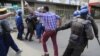 Lovemore Chinoputsa, center, a senior member of opposition Movement for Democratic Change trying to run away from Zimbabwe police arrests in Harare in June 2020. (Columbus Mavhunga/VOA)