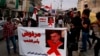 Protesters hold posters showing Iraq's Prime Minister-designate Mohammed Tawfiq Allawi with Arabic that reads, "Rejected by order of the people," during a rally in Baghdad, Iraq, March 1, 2020.