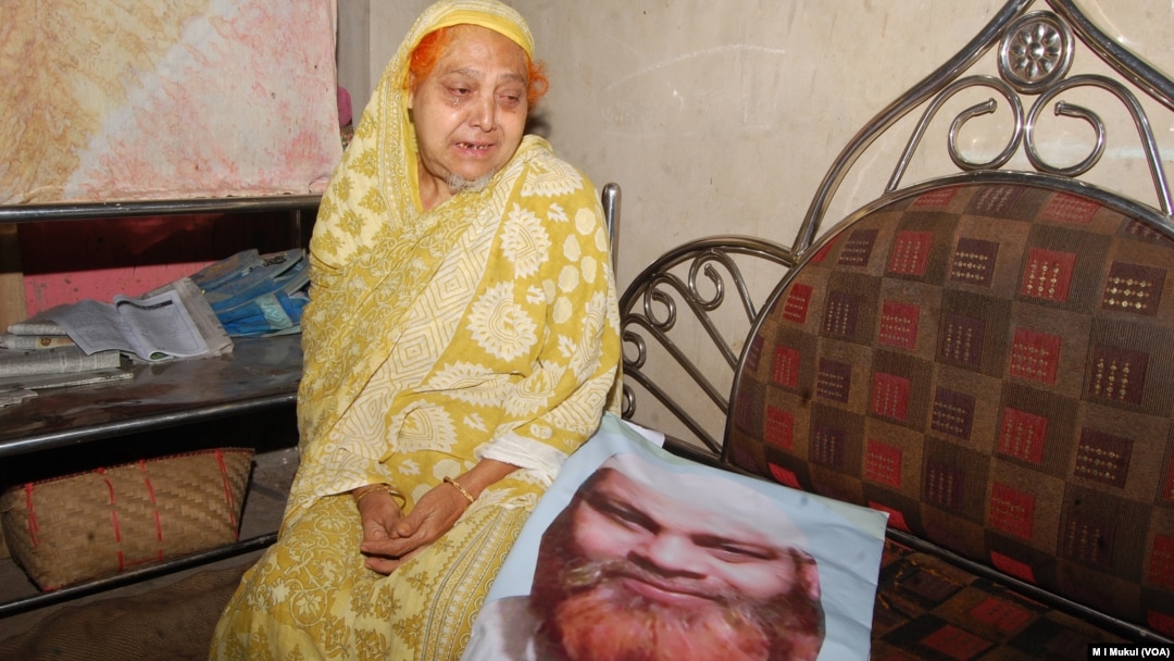 With the photo of Habibur Rahman, his mother sits in her Chittagong home a day after he was killed May 18 in the ongoing anti-drug campaign in Bangladesh. Family members of Rahman insist that he was a religious man and had had no connection with narcotics.