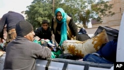 Iraqi security forces and allied Sunni tribal fighters help trapped civilians get to safer areas, in Ramadi, 70 miles (115 kilometers) west of Baghdad, Iraq, on Jan. 2, 2016.