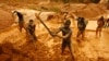Artisanal miners dig for gold in an open-pit concession near Dunkwa, western Ghana, Feb. 15, 2011.
