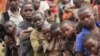 Refugee children, displaced by continued fighting in north Kivu province in the Democratic Republic of Congo (DRC), wait for food in the Nyakabande refugee transit camp in Kisoro town, 521 km (324 miles) southwest of Uganda's capital Kampala, July 13, 201
