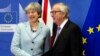 英国首相特蕾莎.梅（左）和欧洲委员会主席容克在布鲁塞尔谈判前握手