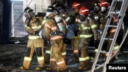 A victim is carried by firefighters in Jecheon, South Korea, Dece. 21, 2017. 