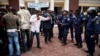Diomi Ndongala (center, wearing suit) and other opposition activists are seen confronting policemen in Kinshasa in this October 13, 2011, file photo.