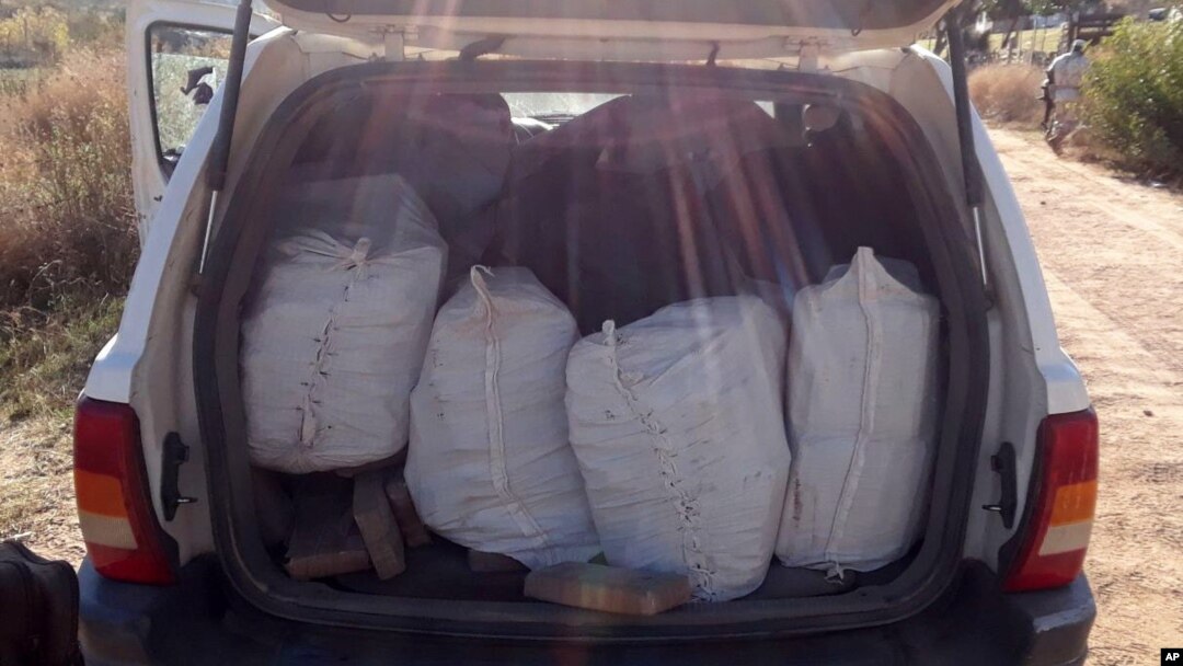 In this Jan. 25, 2018 photo released by Mexico's National Security Commission, packages containing illegal drugs are seen inside a sports utility vehicle near Ensenada, Baja California, Mexico. 