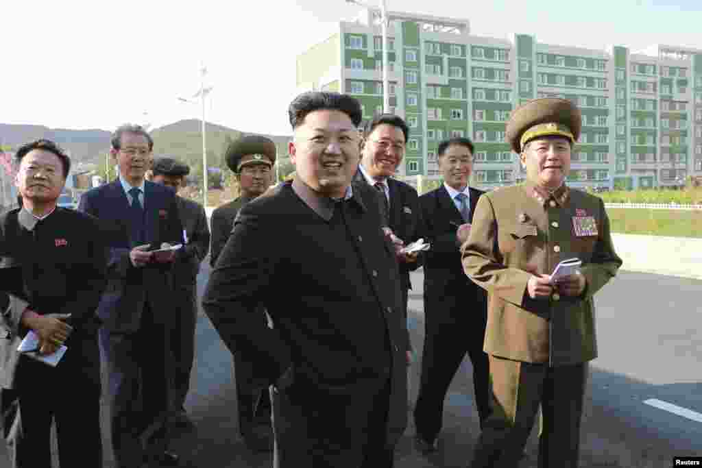 North Korean leader Kim Jong Un arrives at the newly built Wisong Scientists Residential District in this undated photo released by North Korea's Korean Central News Agency (KCNA) in Pyongyang October 14, 2014.