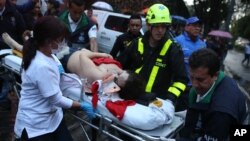 A woman is evacuated on a gurney after an explosion at the Centro Andino shopping center in Bogota, Colombia, June 17, 2017. 