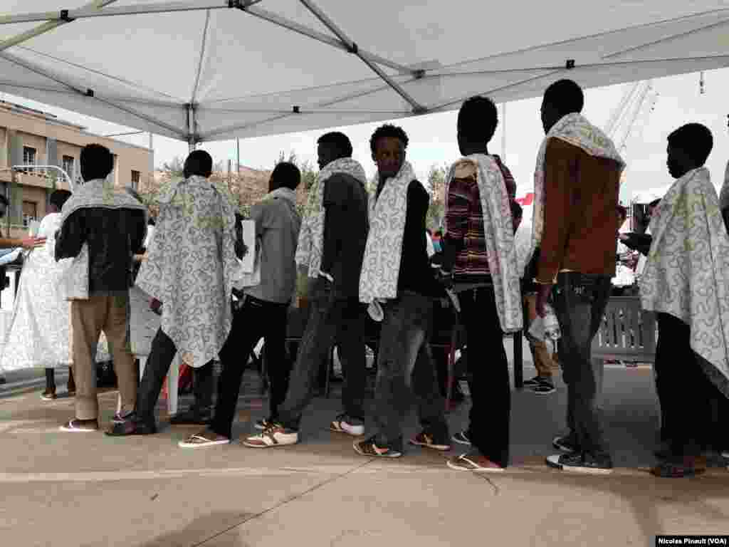 Eritrean migrants disembarking from the “Siem Pilot” in Messina.