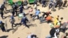 Zimbabwean riot police clash with protestors during a demonstration against the introduction of bond notes by the Reserve Bank of Zimbabwe, in Harare, Aug. 17, 2016.