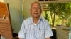 រូបឯកសារ៖ លោក​ មាស មុត​ អតីត​មេបញ្ជាការ​កងទ័ព​ជើង​ទឹក​របស់​របប​ខ្មែរក្រហម​ អង្គុយនៅក្នុង​​​គេហដ្ឋាន​របស់​​លោក​នៅស្រុក​សំឡូត ខេត្តបាត់​ដំបង ថ្ងៃ​ទី​១៦ ខែ​ធ្នូ​ ឆ្នាំ​២០១៩​។ (សុខ ខេមរា/វីអូអេ)