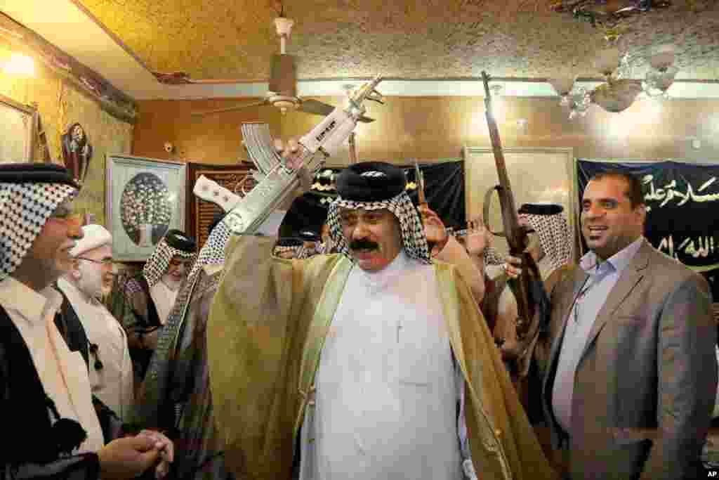 Iraqi Shiite tribal leaders chant slogans against the al-Qaida-inspired Islamic State of Iraq and the Levant (ISIL), in Baghdad, June. 13, 2014. 