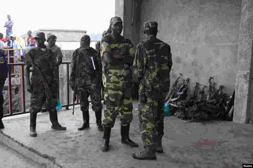 M23 rebels guard weapons given to them by the government's army, Goma, DRC, November 21, 2012.