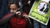 An Egyptian woman cuts her hair during a demonstration in Tahrir Square, Cairo, Egypt, Dec. 25, 2012. 