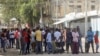 FILE - Somalis gather on a street during fighting between Somali government forces and opposition troops over delayed elections in Mogadishu, Somalia, Feb. 19, 2021. 