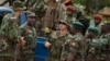FILE - U.S. Army special forces Master Sergeant speaks with troops from the Central African Republic and Uganda, where U.S. special forces have paired up with local troops and Ugandan soldiers to seek out Joseph Kony's LRA, in Obo, Uganda.
