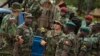FILE - A U.S. Army special forces officer speaks with troops from the Central African Republic and Uganda, in Obo, Central African Republic, April 29, 2012. 