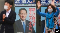 2021年20月27日将举行的一次竞选集会上，日本执政的自民党一个支持者在自民党领袖、首相岸田文雄的竞选广告前挥手。（美联社）