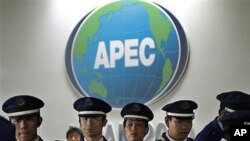 Japanese security officers stand guard at the APEC venue in Yokohama, near Tokyo, 10 Nov 2010