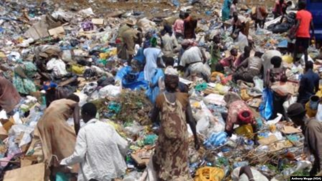South Sudanese pick through a sea of trash outside Juba, looking for plastic bottles that they can exchange for money at a local NGO. 