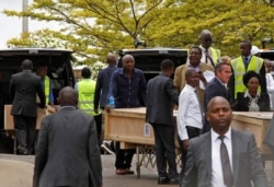 Pallbearers receive coffins of the victims of the March 10 plane crash of Ethiopian Airlines Flight 302, as they arrive at the Jomo Kenyatta International Airport in Nairobi, Kenya, Oct. 14, 2019.