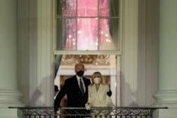 President Joe Biden and first lady Jill Biden watch fireworks from the White House, Wednesday, Jan. 20, 2021, in Washington. (AP Photo/Evan Vucci)