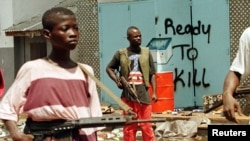 Wani matashi rike da bindiga a birnin Monrovia na Liberiya.