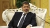 Egypt's President Mohammed Morsi meets with Chinese Vice President Xi Jinping, unseen, at the Great Hall of the People in Beijing, August 29, 2012. 