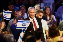 FILE - Blue and White party leader Benny Gantz gets surrounded by his supporters as he arrives to election campaign in Tel Aviv, Israel, Sept. 15, 2019.