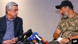 Serzh Sargsyan, left, speaks with protest leader Nikol Pashinian during their meeting in Yerevan, Armenia, April 22, 2018. (Hrant Khachatryan/PAN Photo via AP)