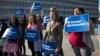 Activists with Planned Parenthood demonstrate in support of a pregnant 17-year-old being held in a Texas facility for unaccompanied immigrant children to obtain an abortion, outside of the Department of Health and Human Services in Washington, Oct. 20, 2017.